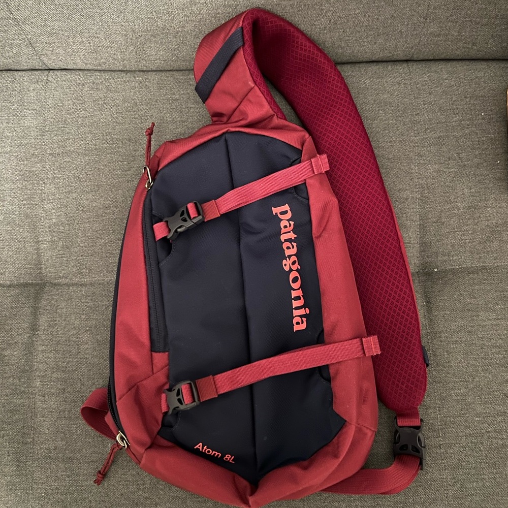 Patagonia navy blue and pink Atom 8L sling bag